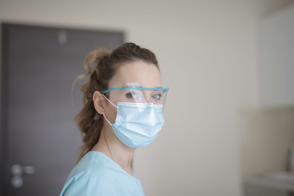 woman in blue shirt wearing face mask min scaled